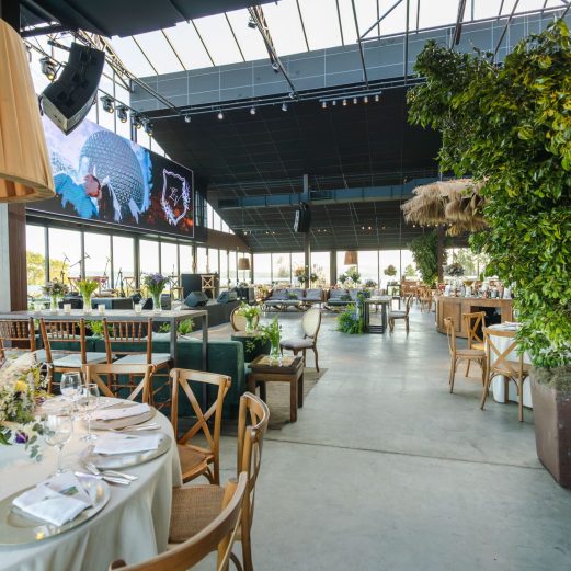 A beautifully decorated indoor reception venue with floral arrangements and elegant table settings.